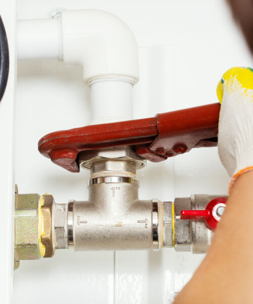 Worker hands fixing heating system
